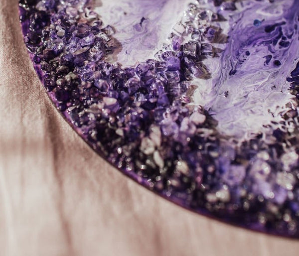Art pieces made with Shallow Cast Epoxy Resin. Purple Pigments and stones.
